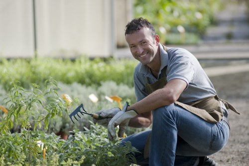 Garden maintenance staff using PPE while working on a lawn